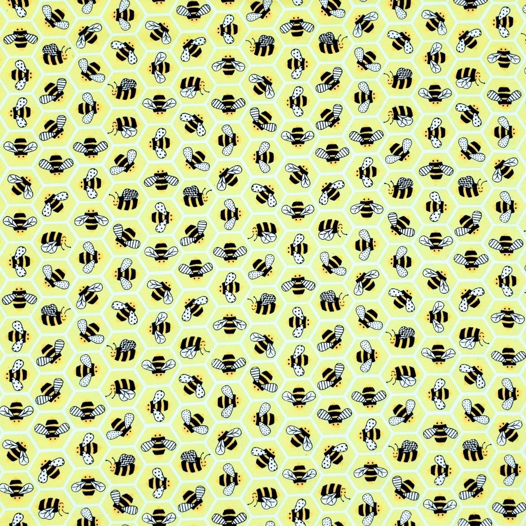 Close-up of yellow bee print cotton fabric used in reusable thong pads