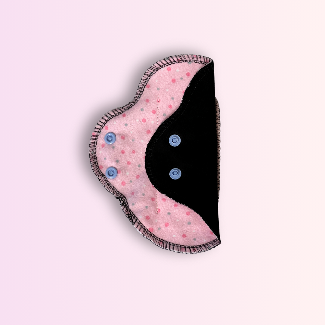 Reusable day pad with pink polka dot design – one wing open- soft and safe menstrual care.