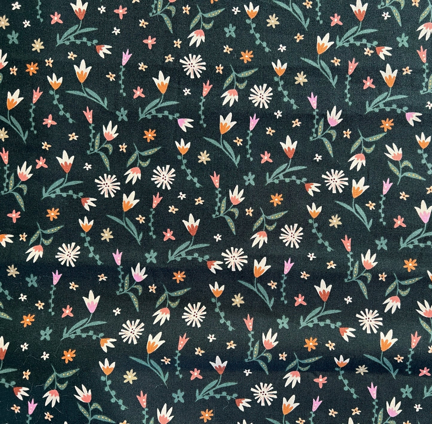 Close-up of dark green floral cotton fabric used for reusable cloth pads