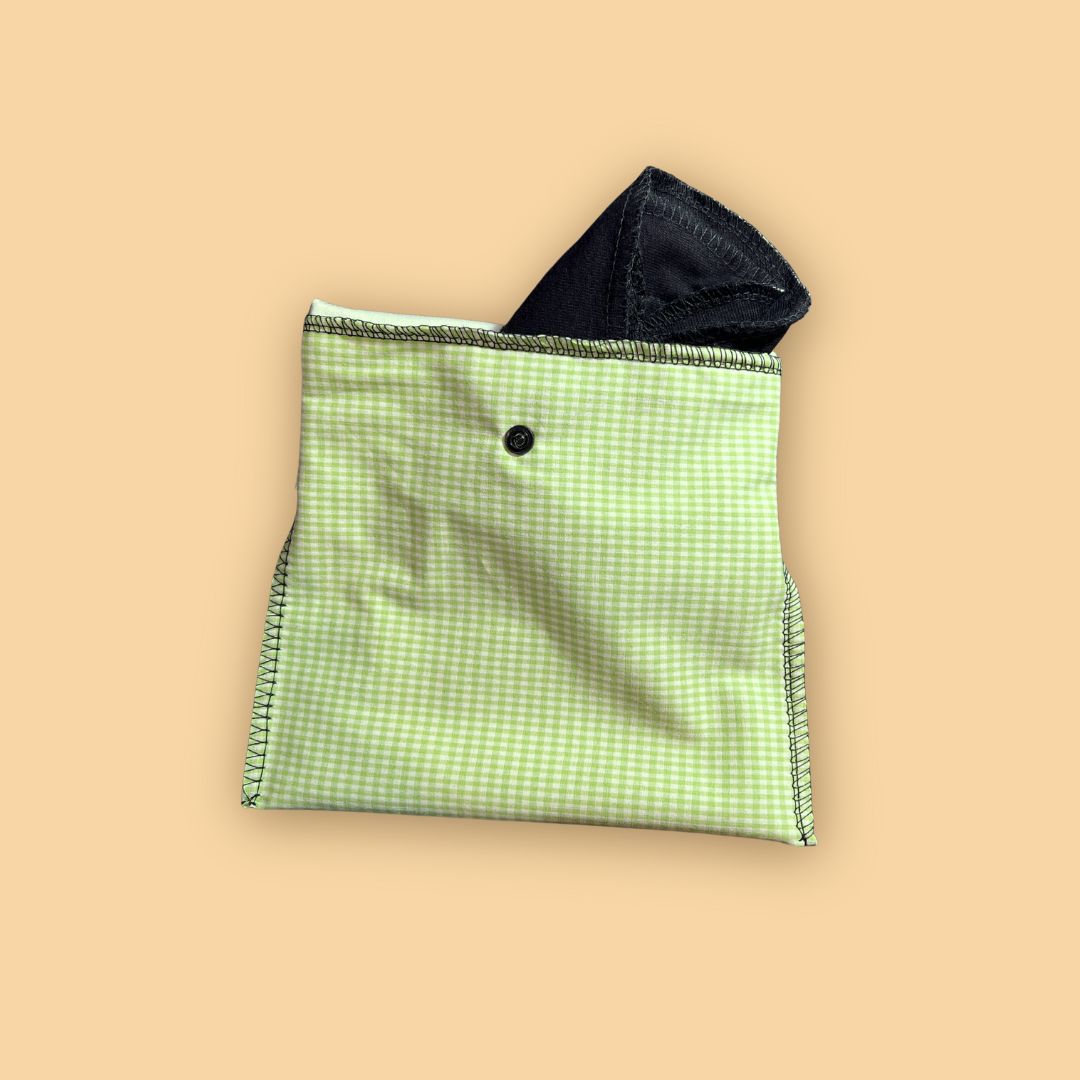 Green reusable pad pouch holding folded cloth pad