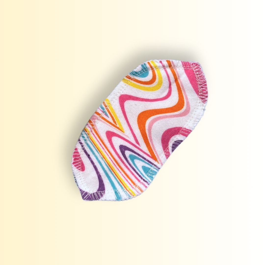 Single reusable interlabial pad in pink swirl design made of cotton flannel