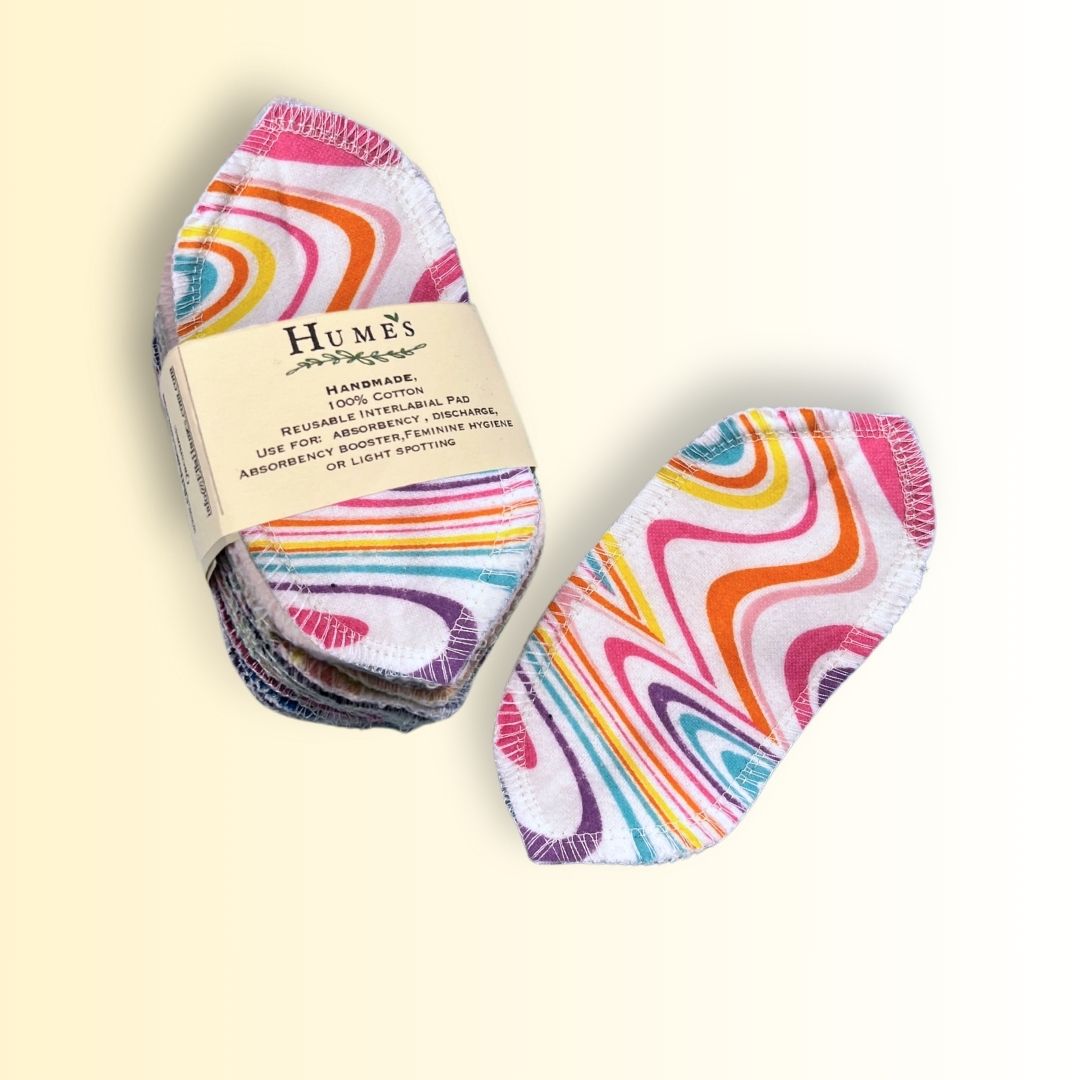 Pack of 15 reusable interlabial pads in pink swirl design with Hume’s packaging