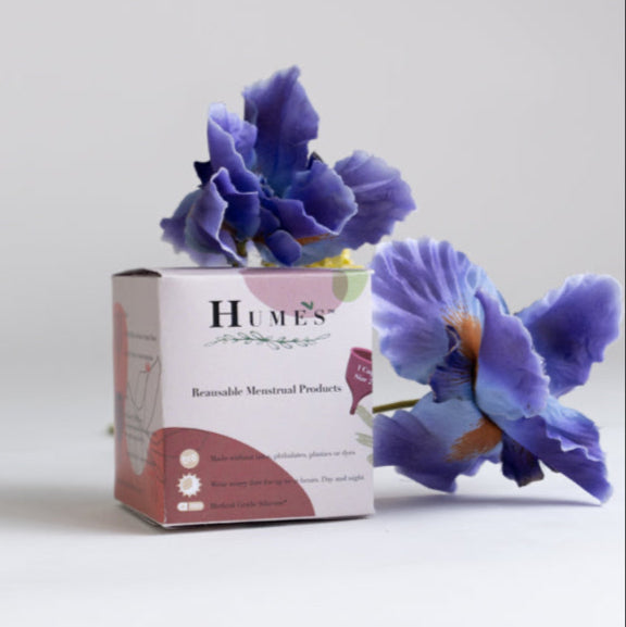 Hume’s menstrual cup box displayed with purple flower on white background