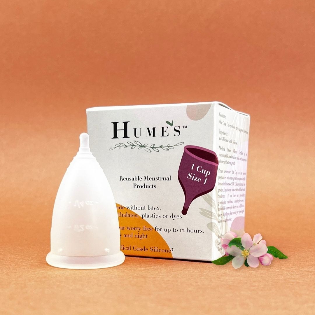 Hume’s menstrual cup size 1 in front of branded box on peach background