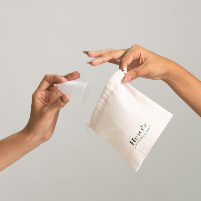 Hume’s menstrual disc placed on branded box against a white background