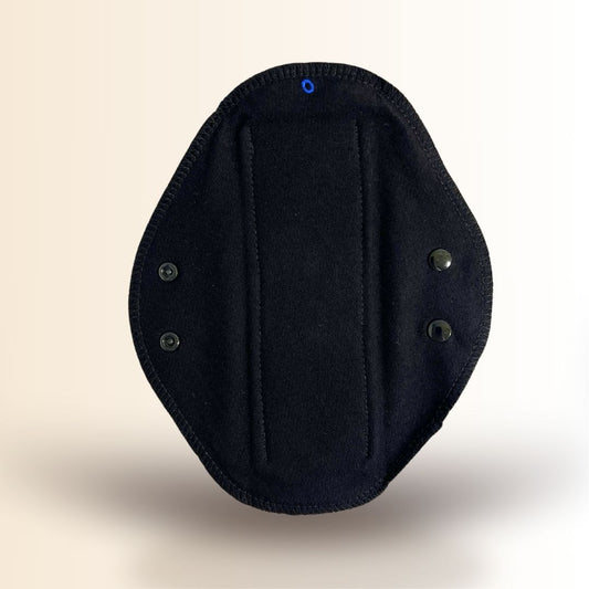 Black reusable cloth day pad with organic cotton core and snap wings for light menstrual flow.