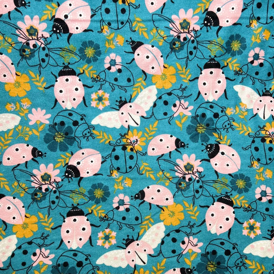 Close-up of fun ladybug and floral pattern on cotton flannel – used for teen cloth pads