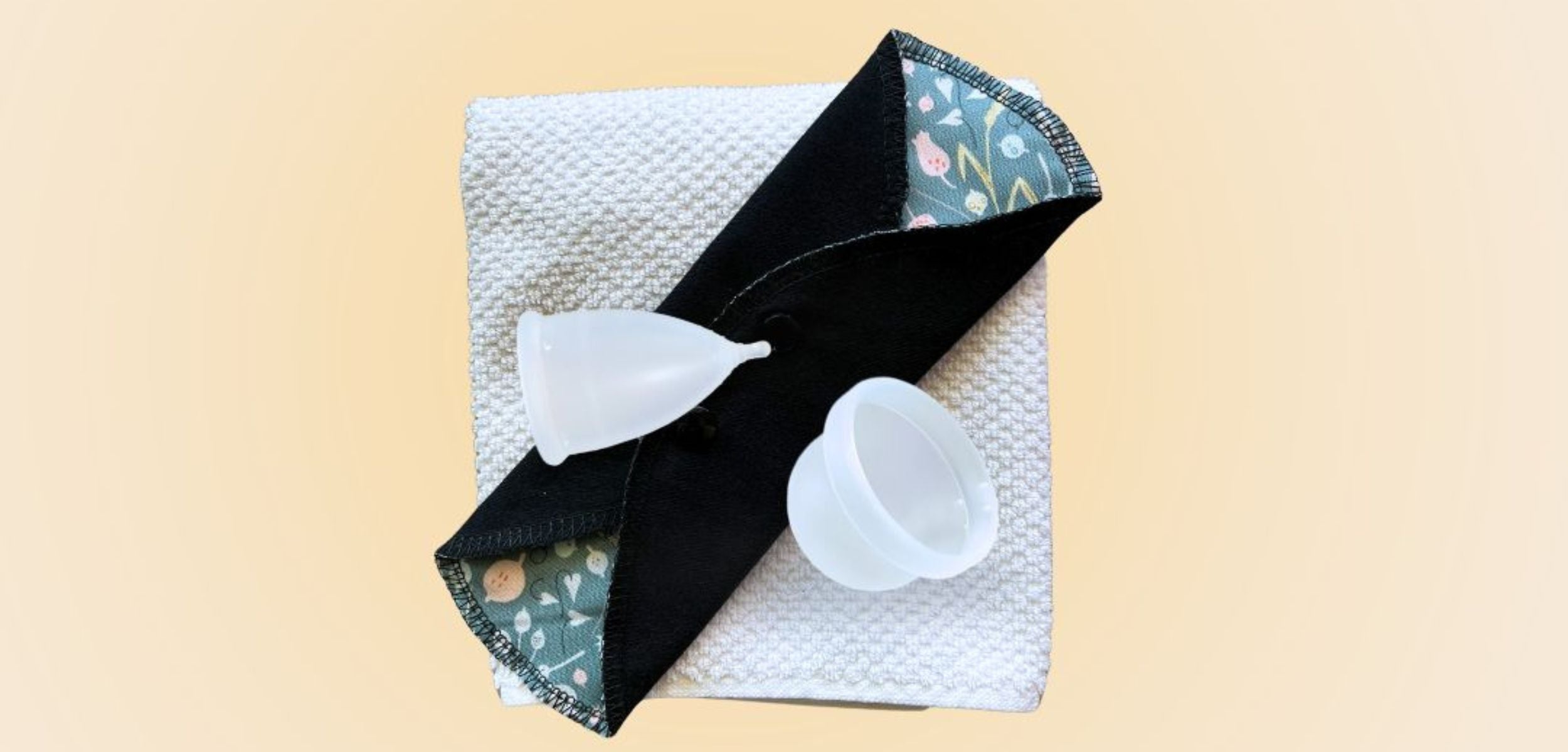 Flatlay of Hume’s reusable period care products including menstrual cup, disc, and cloth pad bundle