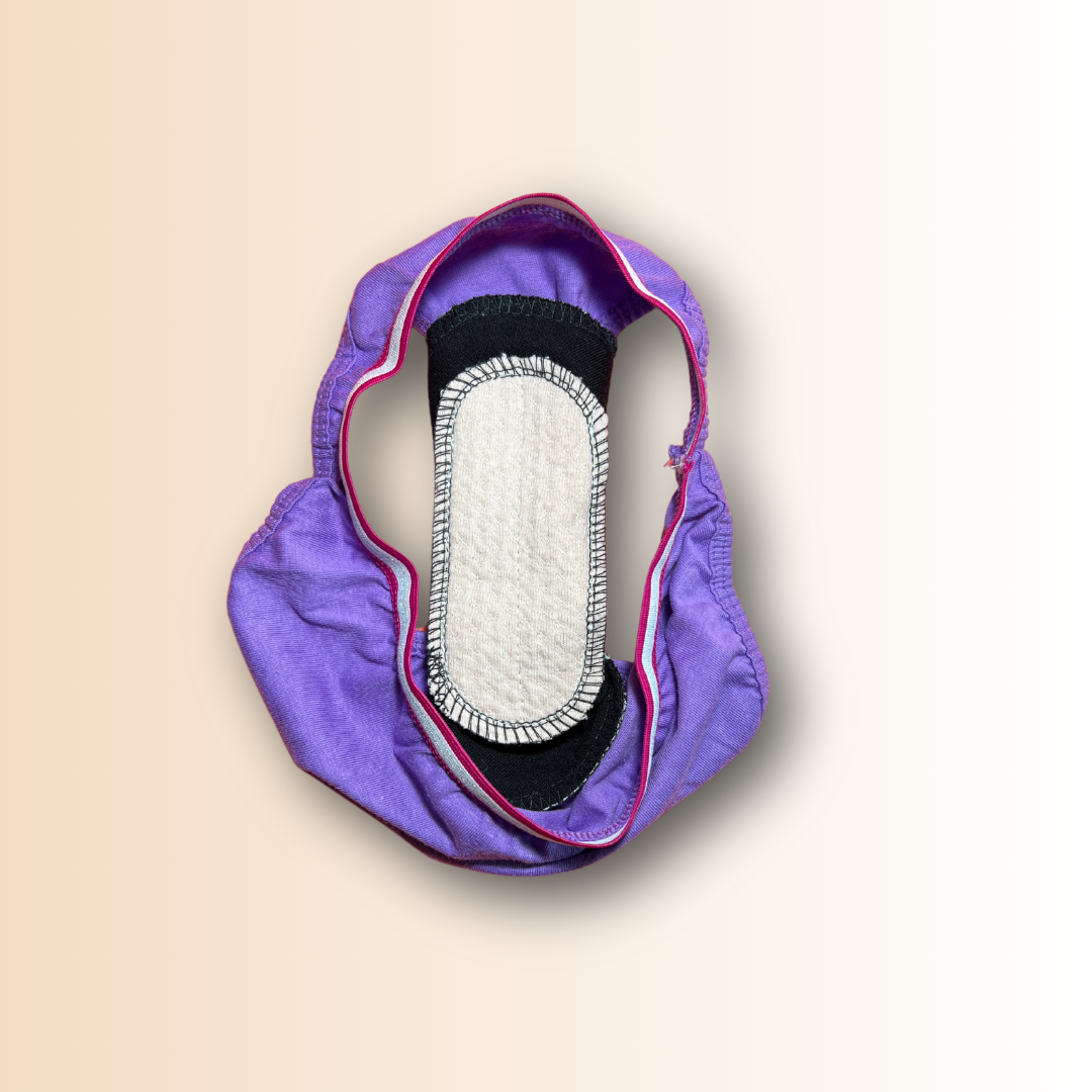 Teen reusable pad snapped into purple underwear – demo of how to wear cloth liners