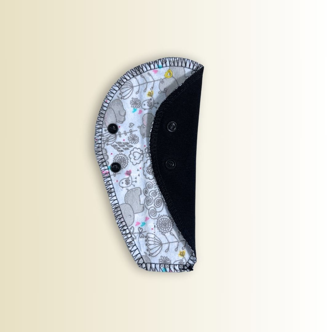 Thong menstrual pad showing black absorbent layer and fun hippo print. Designed for daily wear and thong underwear.