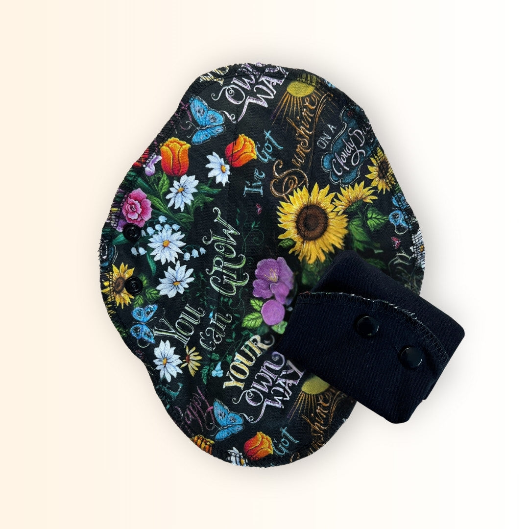 Sunflower floral reusable cloth pads with black cotton lining from Hume’s Period Care.