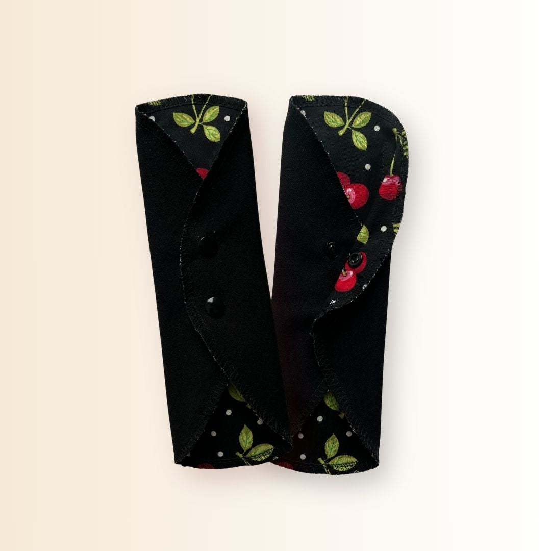 Cherry cloth period pads folded to show snap closure