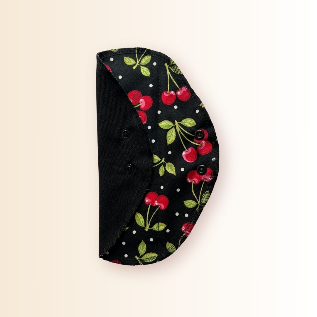 Folded cherry reusable day pad with snap wings and black cotton side