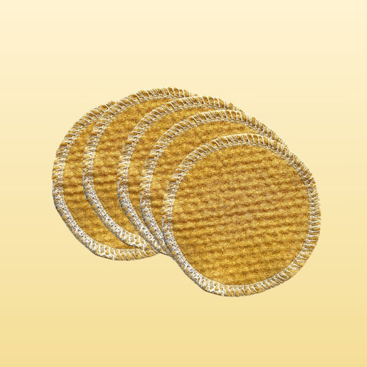 Stack of 100% organic cotton face pads in golden sand color, round reusable design