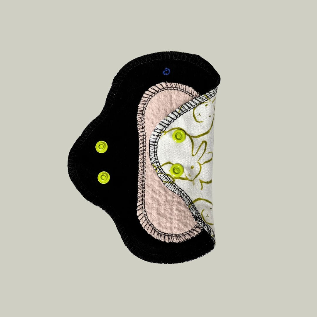 Reusable teen menstrual pad with bunny print showing the soft absorbent side with organic cotton core – skin-facing layer exposed – Hume’s Period Care