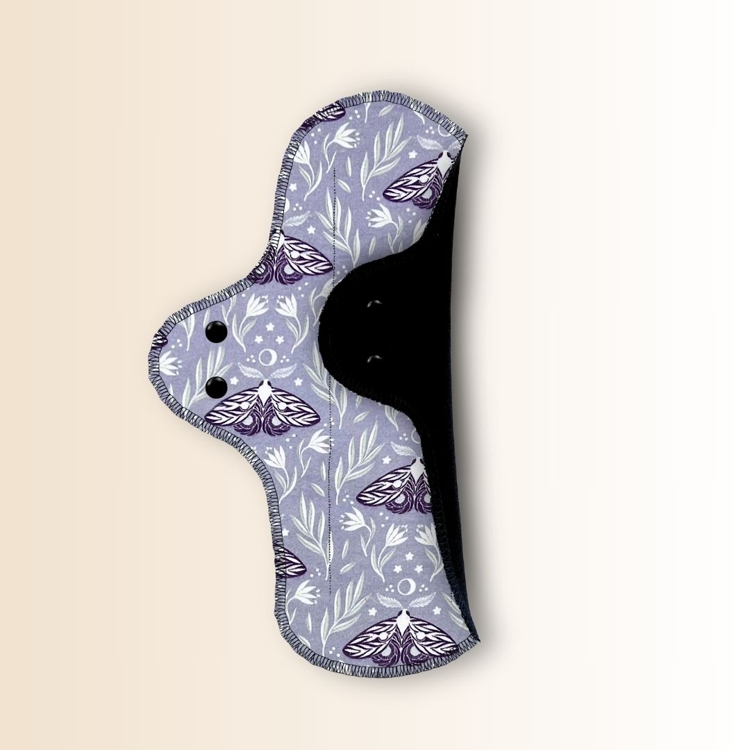 Back one side folded of Hume’s moth print night pad showing, with waterproof PUL layer for overnight protection.