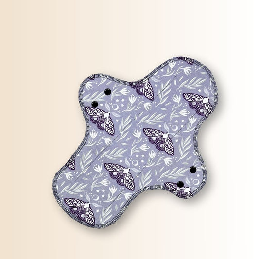  Front view of Hume’s reusable night pad in moth design, featuring flared shape and soft cotton top layer.