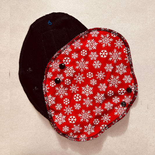 Black reusable menstrual pad with Christmas print — organic cotton core, holiday edition