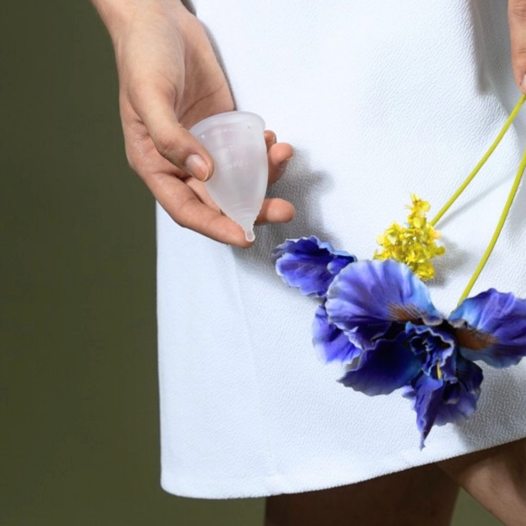 Hand holding a reusable menstrual cup from Hume’s Period Care for soft, longer-wear washable period care.