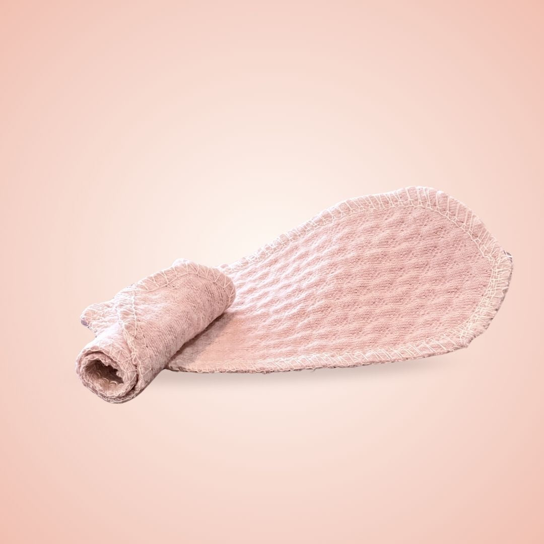 Soft organic interlabial pad shown rolled and flat, made with breathable cotton by Hume’s Period Care.