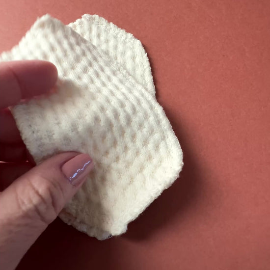 Organic cotton interlabial pad shown in close-up, featuring soft exposed organic cotton and washable reusable design for everyday period care