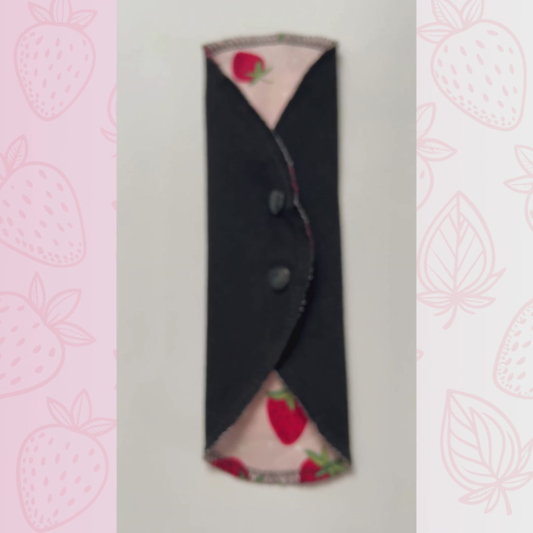 Video showing a strawberry print reusable menstrual pad by Hume’s Period Care.