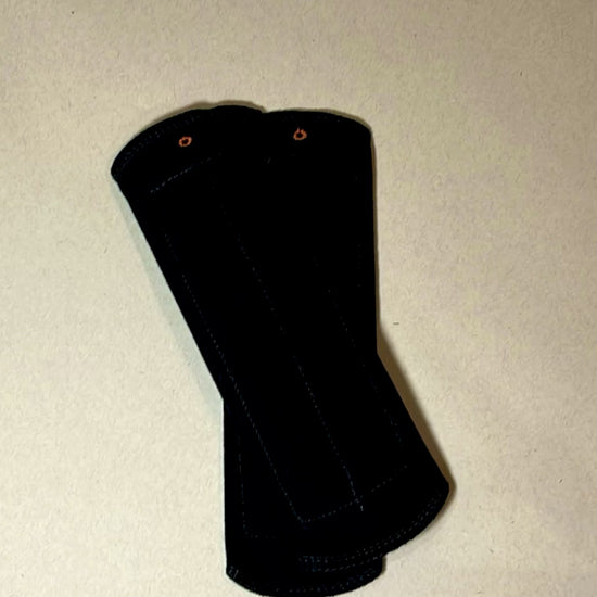 Black reusable day pad shown in close-up, featuring soft cotton fabric, snap closure, and washable design for everyday period care