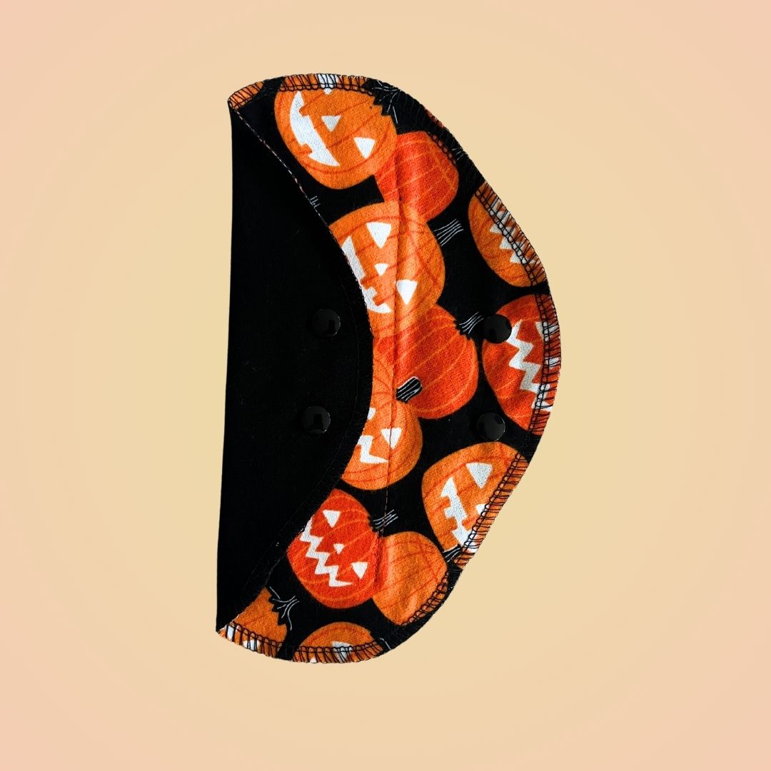 Pumpkin reusable day pad by Hume’s Period Care with orange pumpkin cotton print.