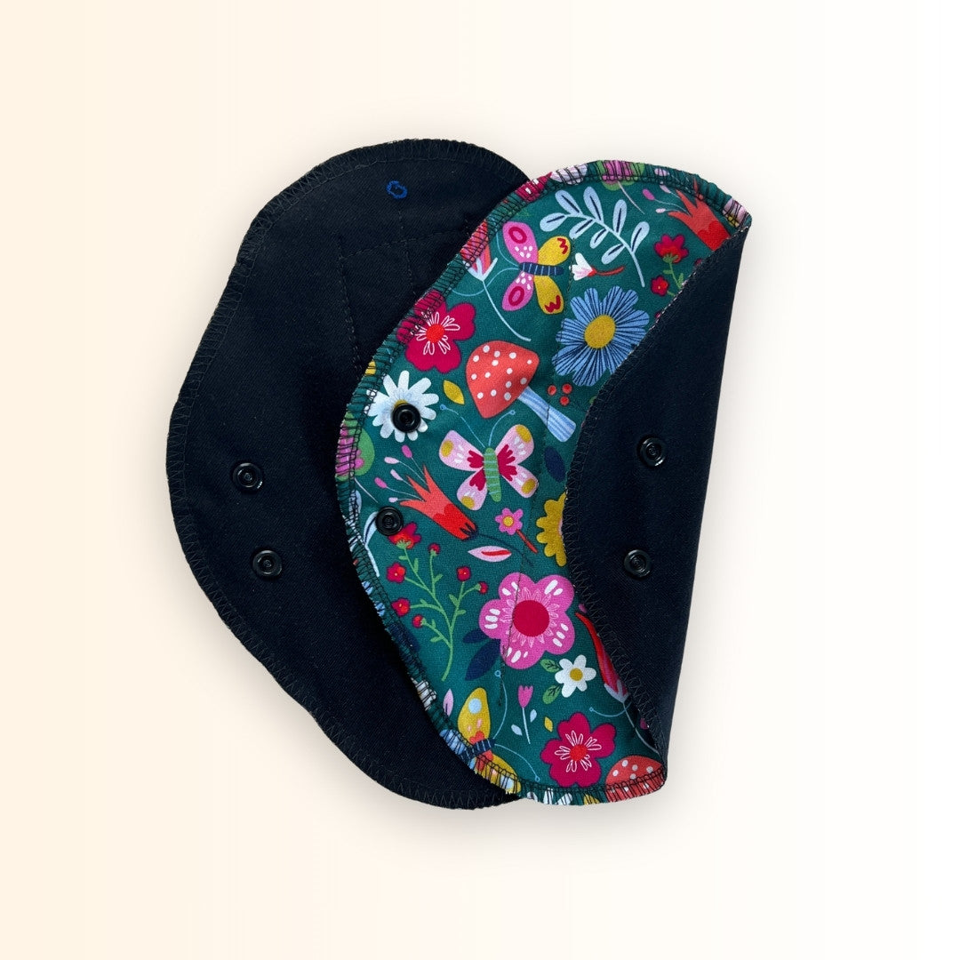 Colorful flower washable period pad with snap wings.