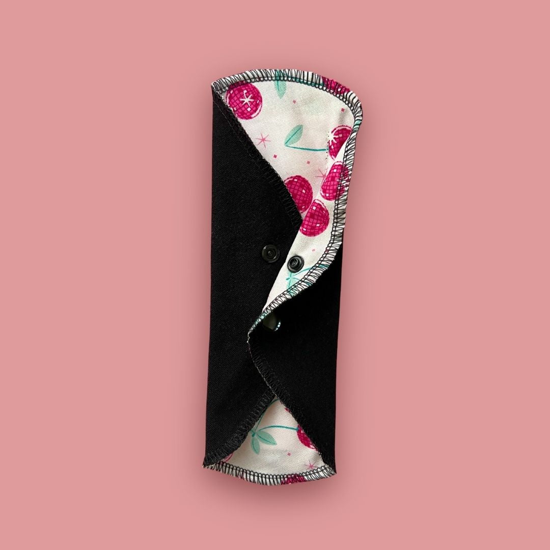 Cherry print reusable cloth pad folded for storage