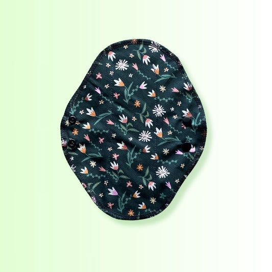 Top view of Hume's reusable day pad in floral green print with 100% cotton fabric