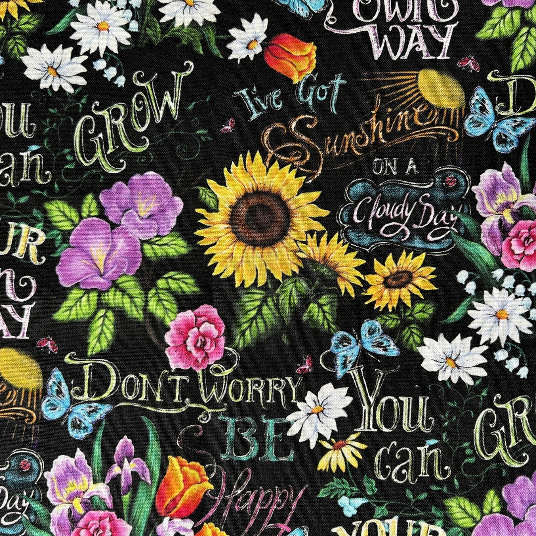 Eco-friendly reusable period pads in a colorful sunflower garden print.