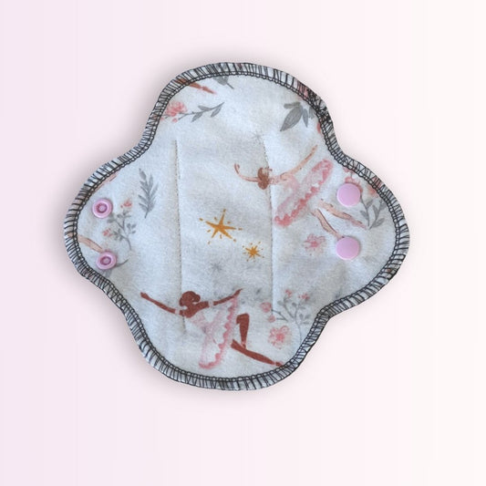 Reusable teen cloth pad in ballerina print, front view. Soft and breathable design with pink snaps for light to medium flow.