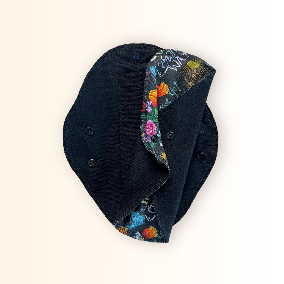 Handmade reusable pads with floral sunflower print and snap closure.