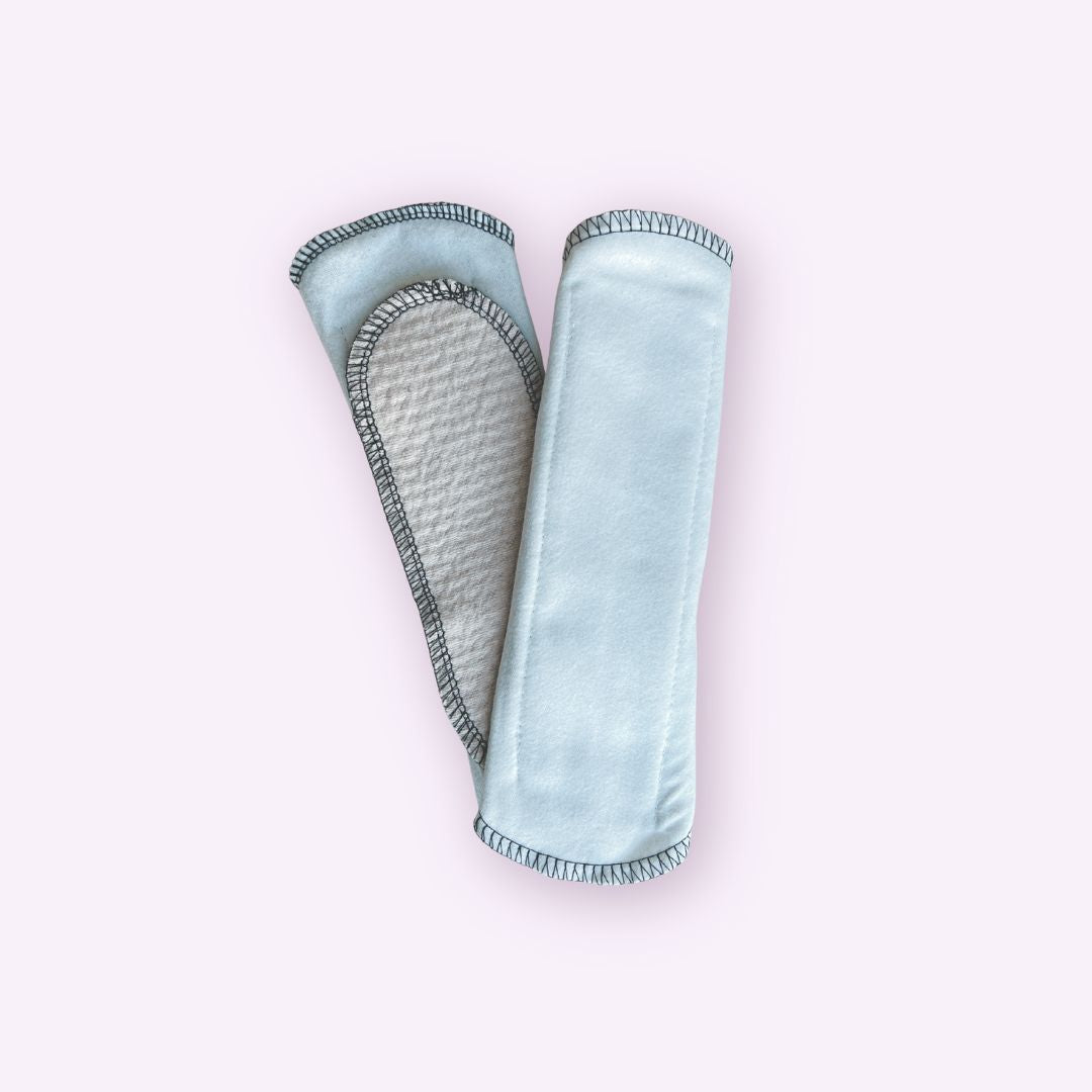 Pair of reusable cloth pads for teens in plain white flannel – one showing absorbent side and one plain side 